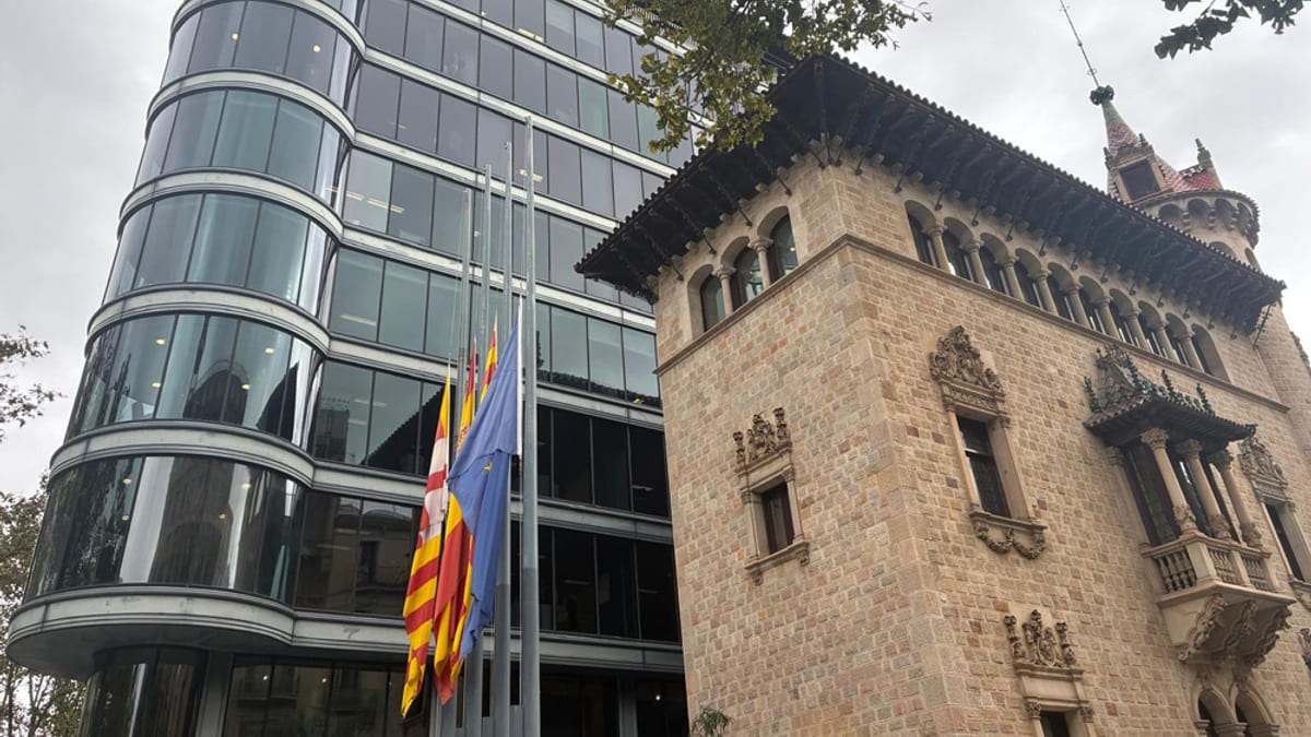 Banderas a media asta en edificios oficiales de la Diputación de Barcelona, mostrando contraste entre arquitectura moderna y histórica