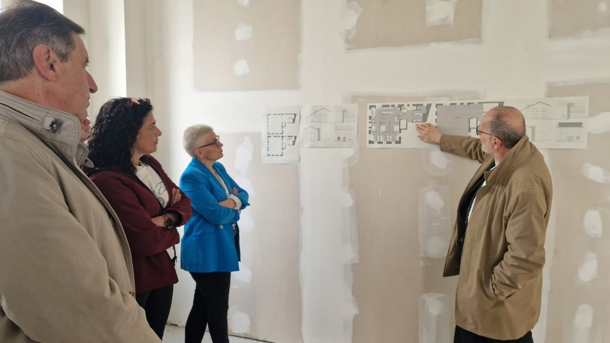 Grupo de técnicos y responsables observando planos arquitectónicos en la visita de seguimiento de las obras del consultorio de La Manjoya
